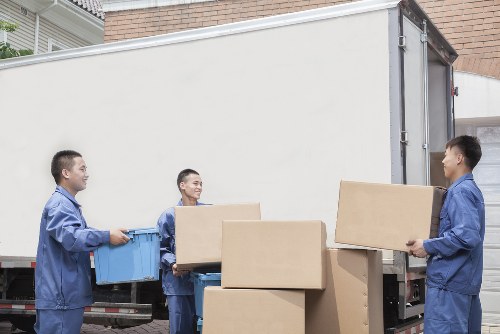 Movers handling furniture safely during a house move