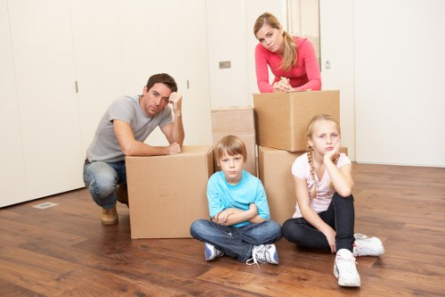 Professional office movers handling furniture and cartons in a local commercial move