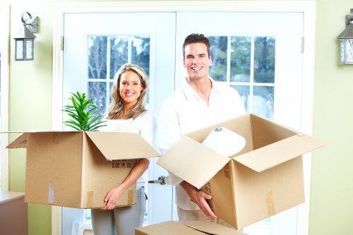 Moving boxes and protected furniture prepared for a flat removal service
